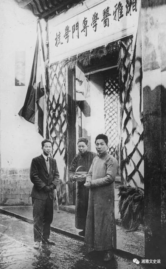 A group of men standing outside a building

Description automatically generated